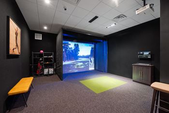 a large screen in a room with a bench in front of it